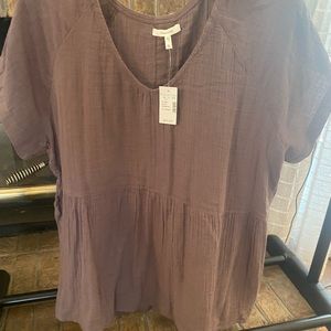 Cute tan shirt. Tags have been removed but never worn.